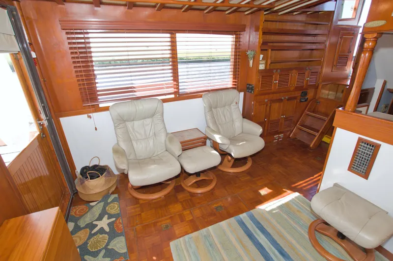 Slide: The Image of Interior of 1980 Kadey-Krogen 42 trawler with leather chairs and wooden decor. - 40
