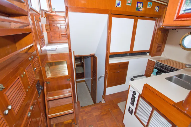 Slide: The Image of Interior of 1980 Kadey-Krogen 42 trawler with wooden cabinetry and compact kitchen area. - 46