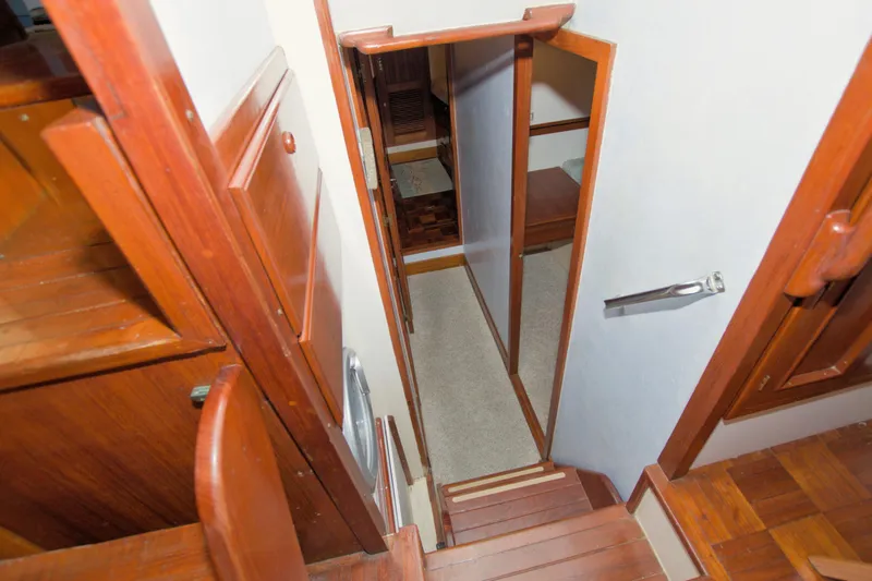 Slide: The Image of Interior view of 1980 Kadey-Krogen 42 trawler, featuring wooden stairs and cabin access. - 47