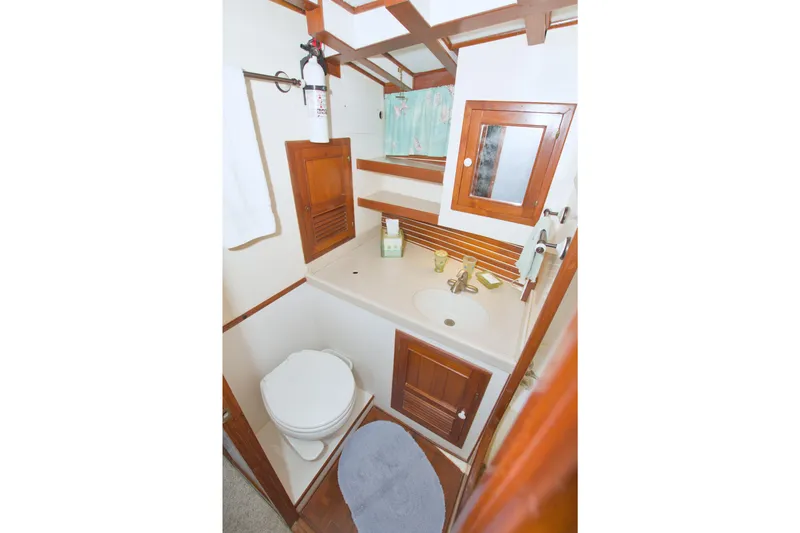 Slide: The Image of 1980 Kadey-Krogen 42 trawler bathroom with wooden cabinetry and compact design. - 50