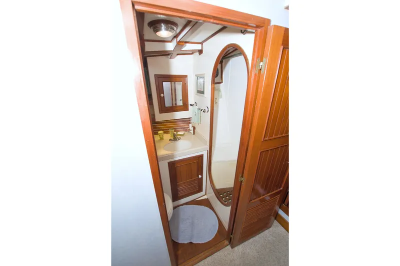 Slide: The Image of 1980 Kadey-Krogen 42 trawler bathroom with wooden cabinetry and compact design. - 51