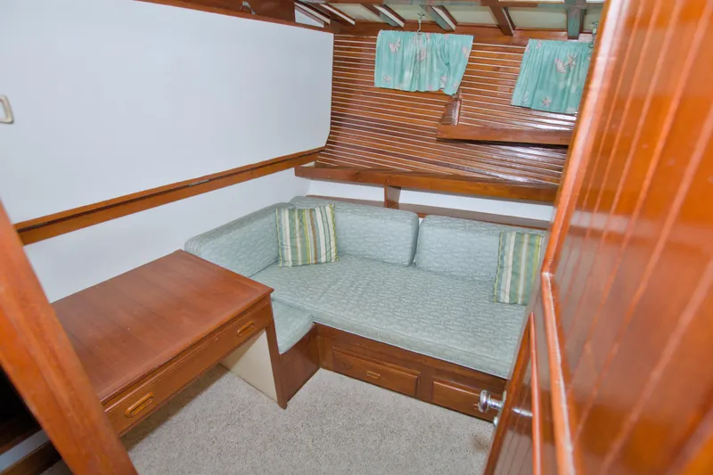 Slide: The Image of Cozy cabin interior of 1980 Kadey-Krogen 42 trawler with wooden desk and seating. - 54