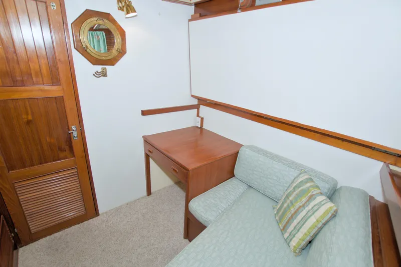 Slide: The Image of 1980 Kadey-Krogen 42 trawler interior with wooden desk, sofa, and nautical decor. - 55