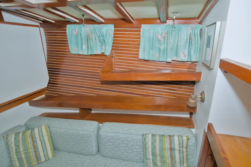 Slide: The Image of Interior of 1980 Kadey-Krogen 42 trawler with wooden paneling and patterned curtains. - 57