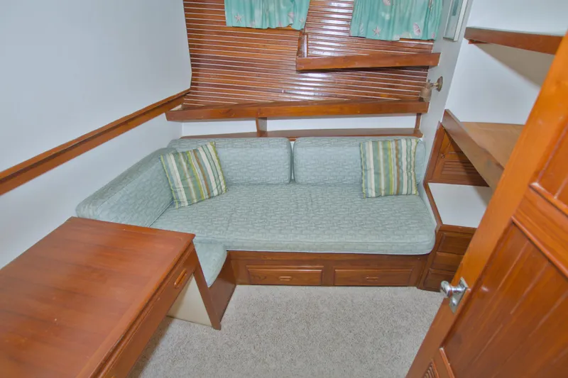 Slide: The Image of Cozy cabin interior of 1980 Kadey-Krogen 42 trawler with sofa and wooden shelves. - 58