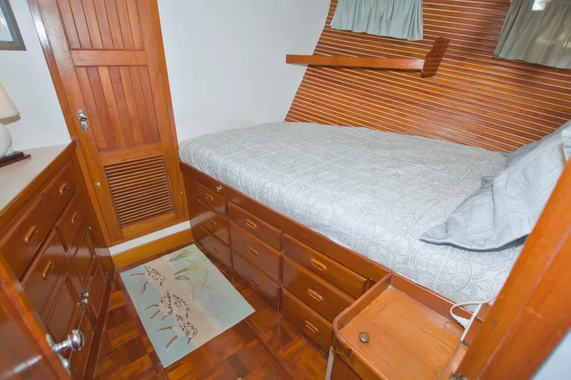 Slide: The Image of Cozy cabin interior of 1980 Kadey-Krogen 42 trawler with wooden furnishings and bed. - 61