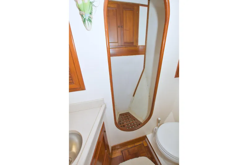 Slide: The Image of 1980 Kadey-Krogen 42 trawler bathroom with wooden accents and compact design. - 66