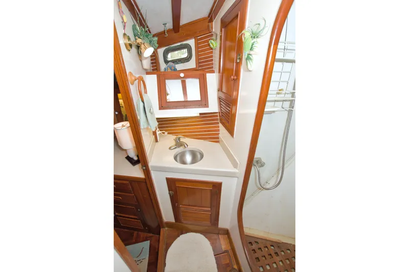 Slide: The Image of 1980 Kadey-Krogen 42 trawler bathroom with wooden cabinetry and stainless steel sink. - 67
