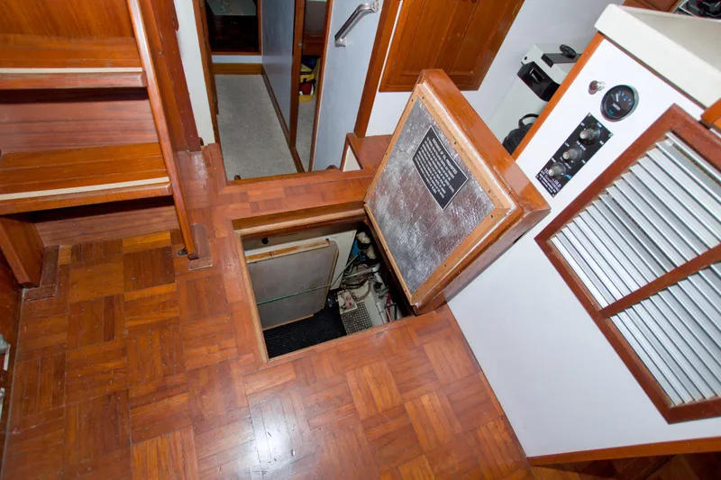 Slide: The Image of Interior of 1980 Kadey-Krogen 42 trawler showing wooden flooring and engine access hatch. - 68