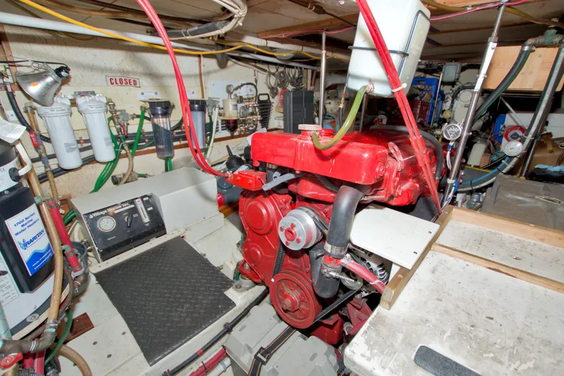Slide: The Image of Engine room of 1980 Kadey-Krogen 42 trawler with red machinery and various equipment. - 69