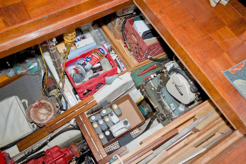 Slide: The Image of Engine room of a 1980 Kadey-Krogen 42 trawler with tools and supplies. - 75
