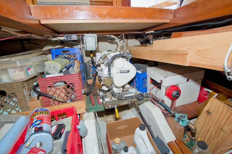 Slide: The Image of Engine room of a 1980 Kadey-Krogen 42 trawler with various tools and equipment. - 76