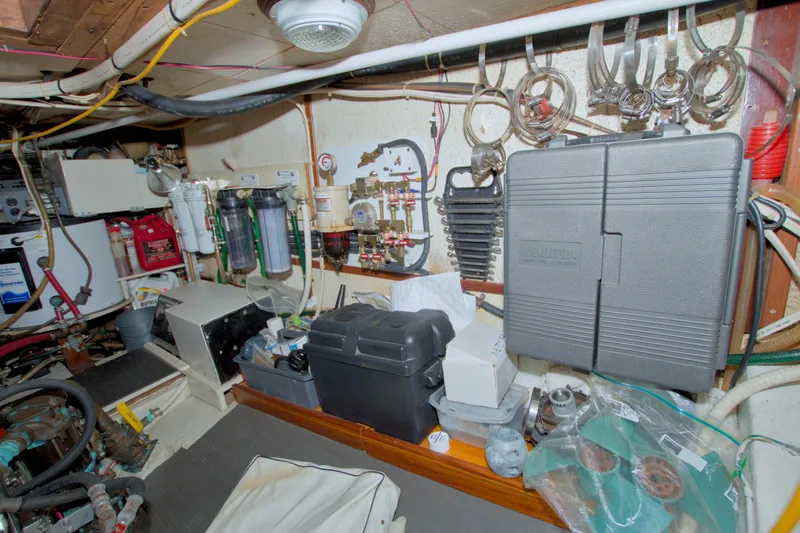 Slide: The Image of Engine room of a 1980 Kadey-Krogen 42 trawler with various equipment and tools. - 78