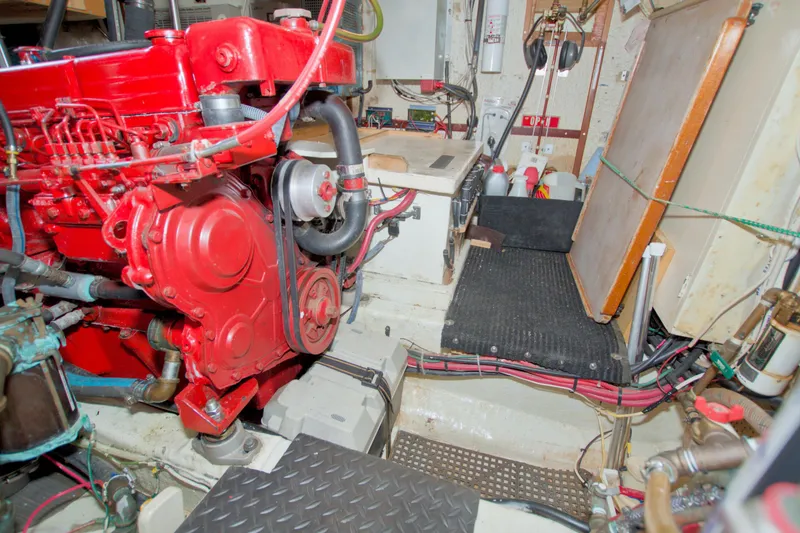 Slide: The Image of Engine room of 1980 Kadey-Krogen 42 trawler with red machinery and organized wiring. - 83