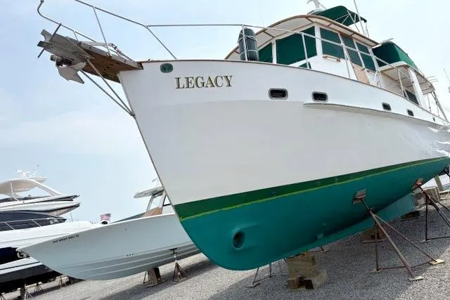 Slide: The Image of 1980 Kadey-Krogen 42 trawler named "Legacy" on dry dock, showcasing classic design. - 87