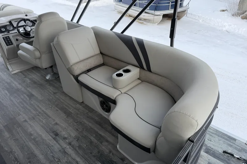 Slide: The Image of 2019 Crest Classic 230 SLC boat interior with plush seating and cup holders. - 16