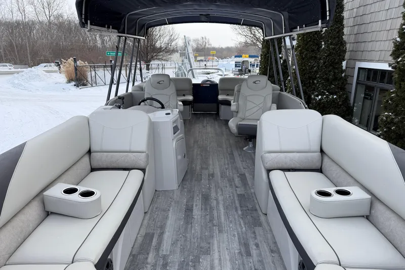 Slide: The Image of 2019 Crest Classic 230 SLC pontoon boat interior with gray seating and cup holders. - 4