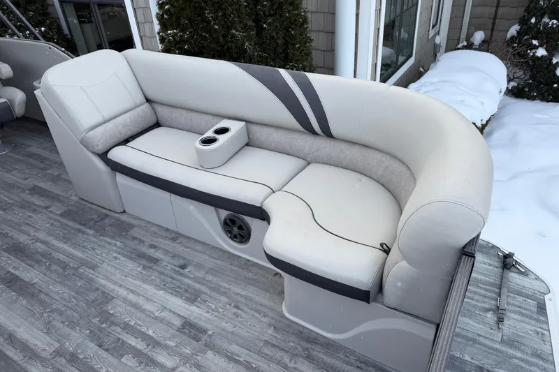 Slide: The Image of 2019 Crest Classic 230 SLC boat seating with cup holders, snowy background. - 5
