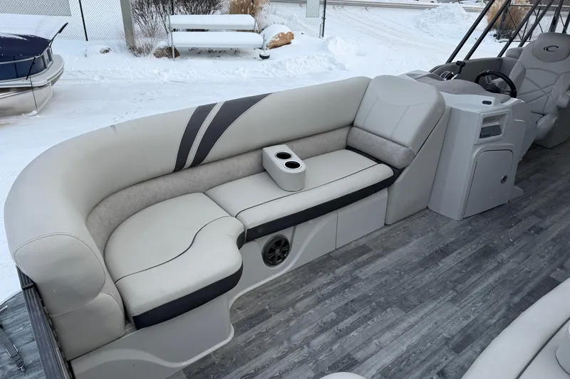 Slide: The Image of 2019 Crest Classic 230 SLC pontoon boat interior with plush seating and cup holders. - 6