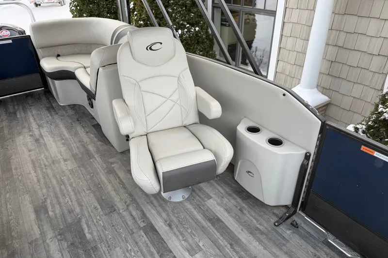 Slide: The Image of 2019 Crest Classic 230 SLC boat interior with luxurious seating and cup holders. - 7