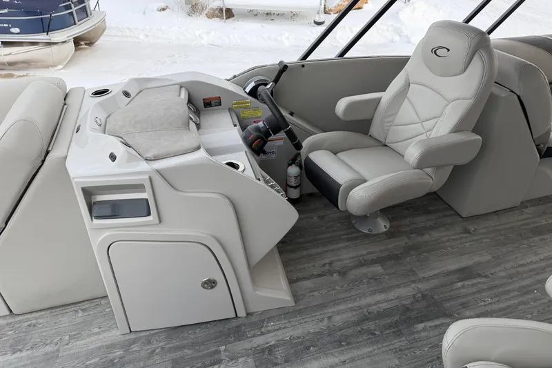 Slide: The Image of 2019 Crest Classic 230 SLC boat interior with captain's chair and control panel. - 8