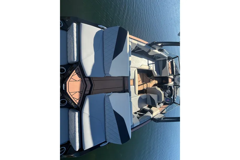Slide: The Image of 2022 Tigé Z1 boat interior with luxurious seating on calm water. - 3