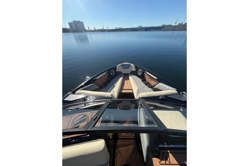 Slide: The Image of 2022 Tigé Z1 boat interior with luxurious seating on calm water. - 4