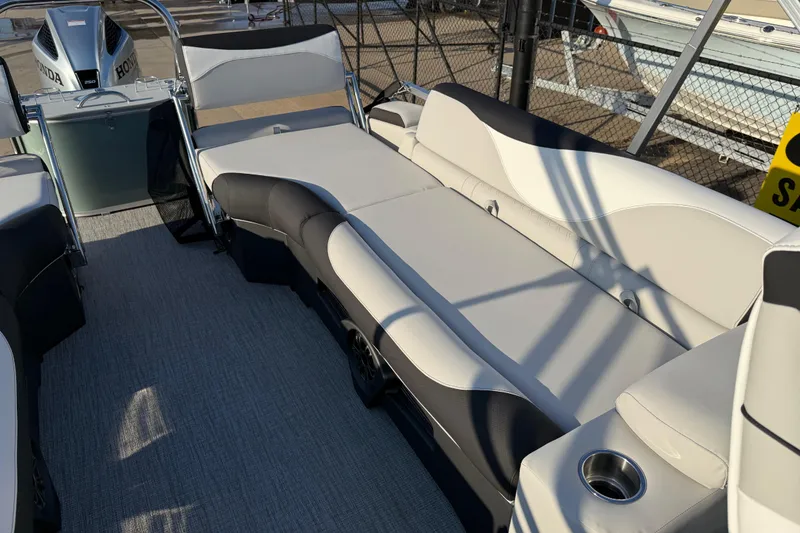 Slide: The Image of 2026 Avalon LSZ Quad Lounger Shift boat interior with plush seating and cup holder. - 14