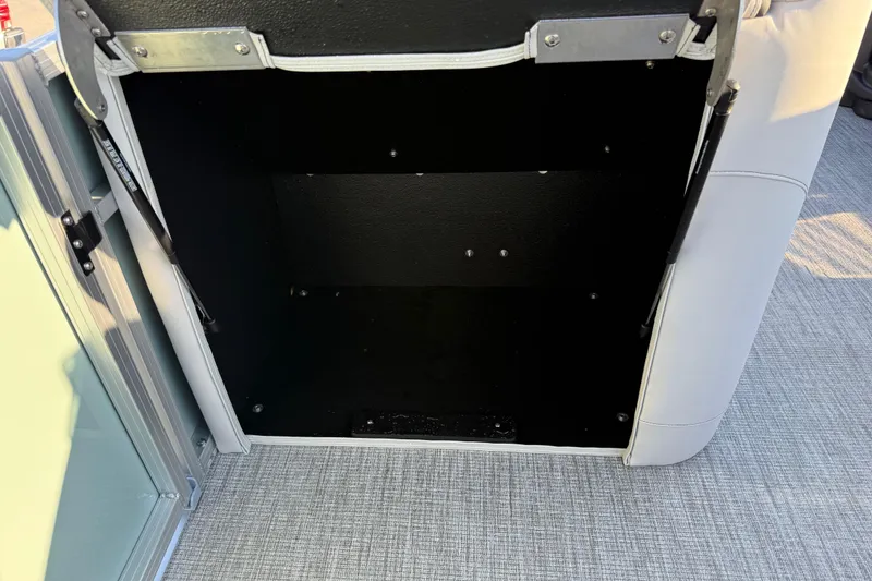 Slide: The Image of Open storage compartment in 2026 Avalon LSZ Quad Lounger Shift boat. - 35