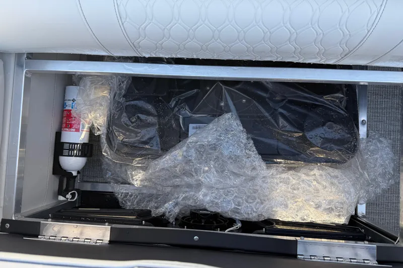 Slide: The Image of Storage compartment of 2026 Avalon LSZ Quad Lounger Shift with fire extinguisher and bubble wrap. - 38