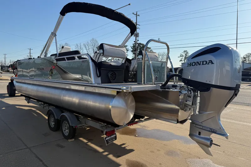 Slide: The Image of 2026 Avalon LSZ Quad Lounger Shift pontoon boat with Honda outboard motor on trailer. - 8