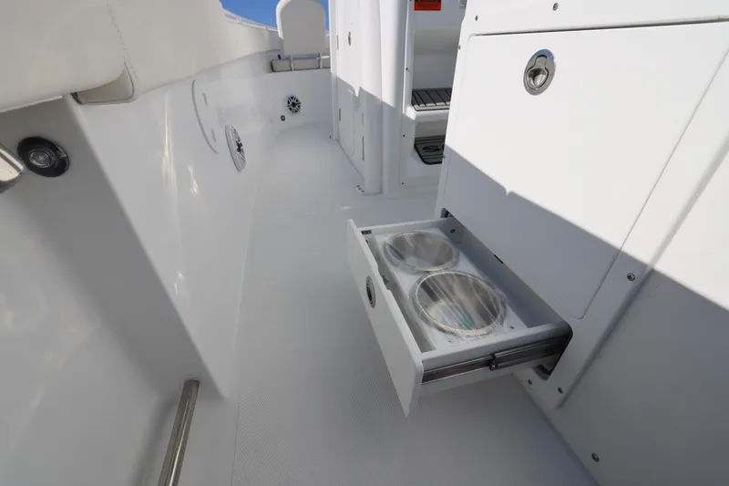 Slide: The Image of 2026 Sea Hunt Ultra 275 SE boat interior with open storage drawer. - 12