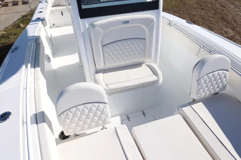 Slide: The Image of 2026 Sea Hunt Ultra 275 SE boat interior with white cushioned seating. - 13