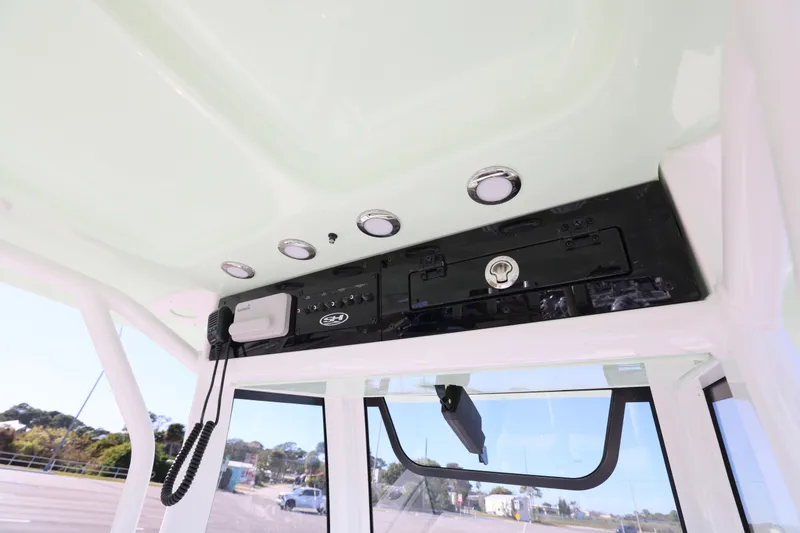 Slide: The Image of 2026 Sea Hunt Ultra 275 SE boat console with radio and storage compartment. - 15