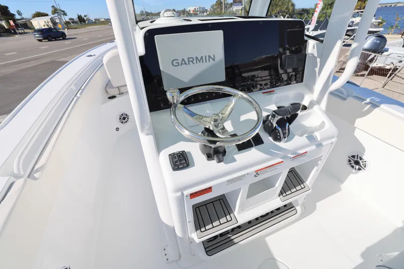 Slide: The Image of 2026 Sea Hunt Ultra 275 SE boat console with Garmin navigation system and steering wheel. - 16
