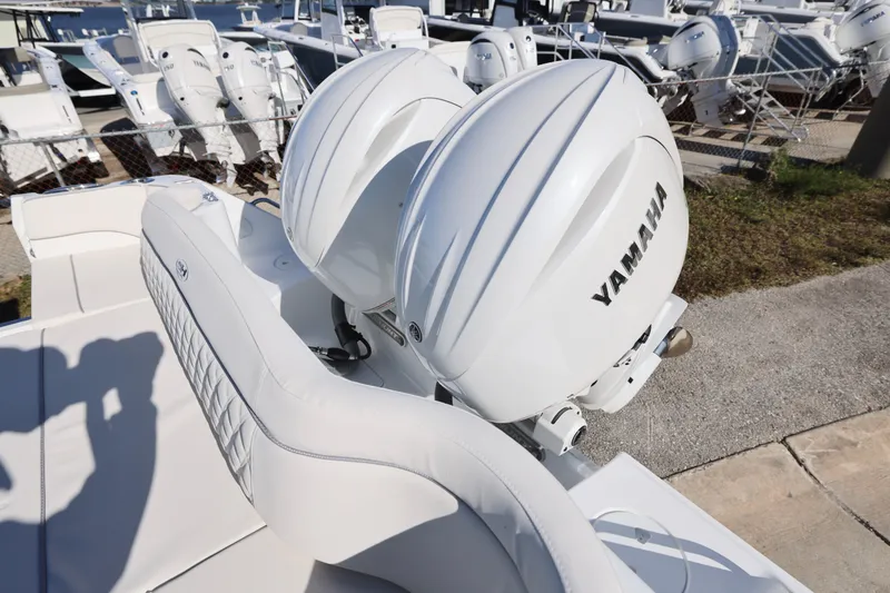 Slide: The Image of 2026 Sea Hunt Ultra 275 SE with dual Yamaha outboard motors, docked at a marina. - 20