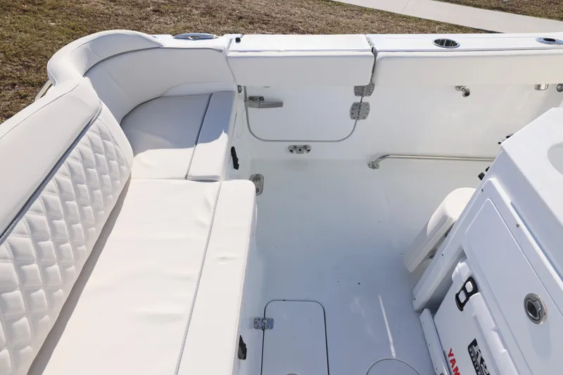 Slide: The Image of 2026 Sea Hunt Ultra 275 SE boat interior with white cushioned seating and storage compartments. - 24
