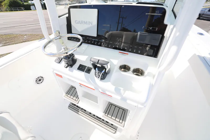 Slide: The Image of 2026 Sea Hunt Ultra 275 SE boat console with Garmin navigation system and steering wheel. - 3
