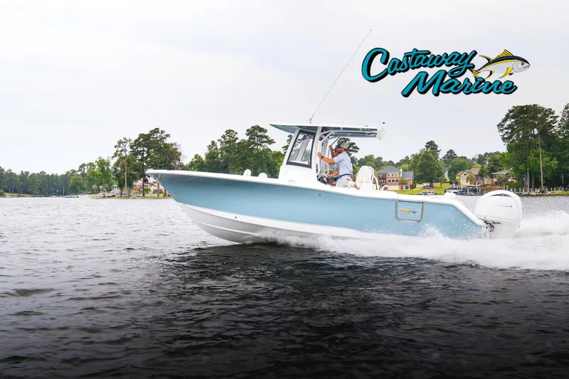 Slide: The Image of 2026 Sea Hunt Ultra 275 SE boat cruising on a lake near a wooded shoreline. - 32