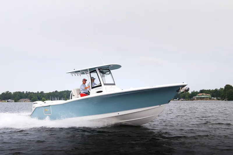 Slide: The Image of 2026 Sea Hunt Ultra 275 SE boat cruising on a lake with trees in the background. - 40