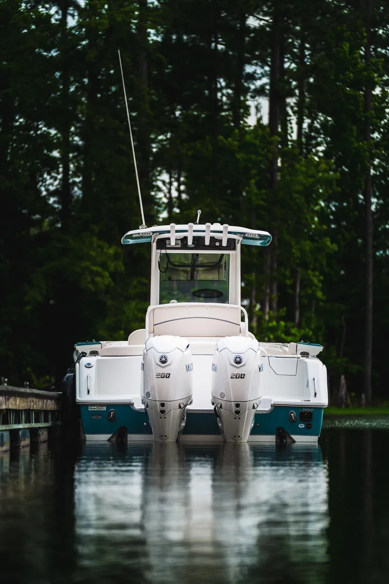 Slide: The Image of 2026 Sea Hunt Ultra 275 SE boat with dual engines on a calm lake. - 44