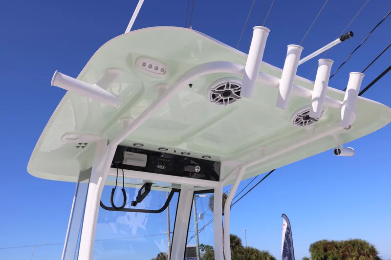 Slide: The Image of 2026 Sea Hunt Ultra 275 SE boat top with rod holders and speakers against blue sky. - 5
