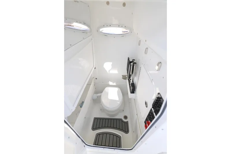 Slide: The Image of 2026 Sea Hunt Ultra 275 SE boat interior with compact marine toilet. - 8