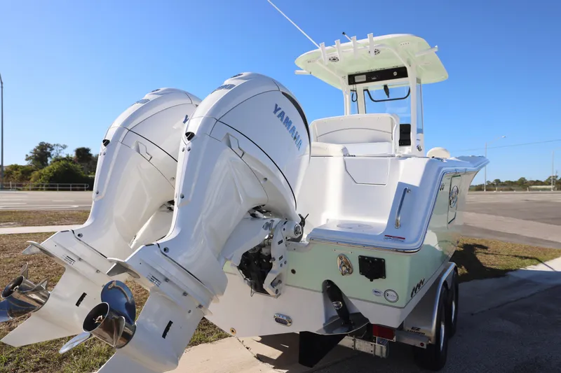 Slide: The Image of 2026 Sea Hunt Ultra 275 SE boat with dual Yamaha outboard engines, parked on a trailer. - 9