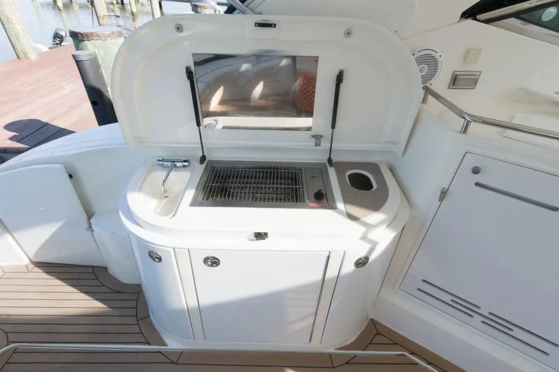 Slide: The Image of Outdoor kitchen area on a 2005 Cruisers Yachts 520 Express. - 14