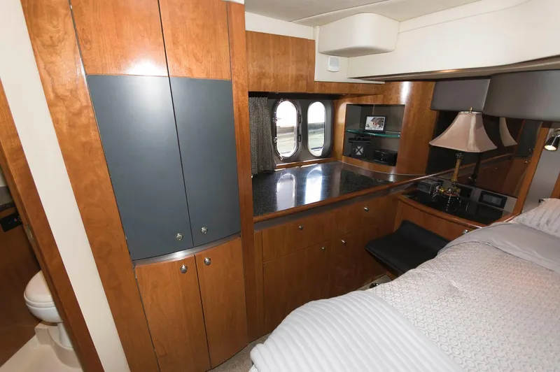 Slide: The Image of 2005 Cruisers Yachts 520 Express cabin interior with wood cabinetry. - 29