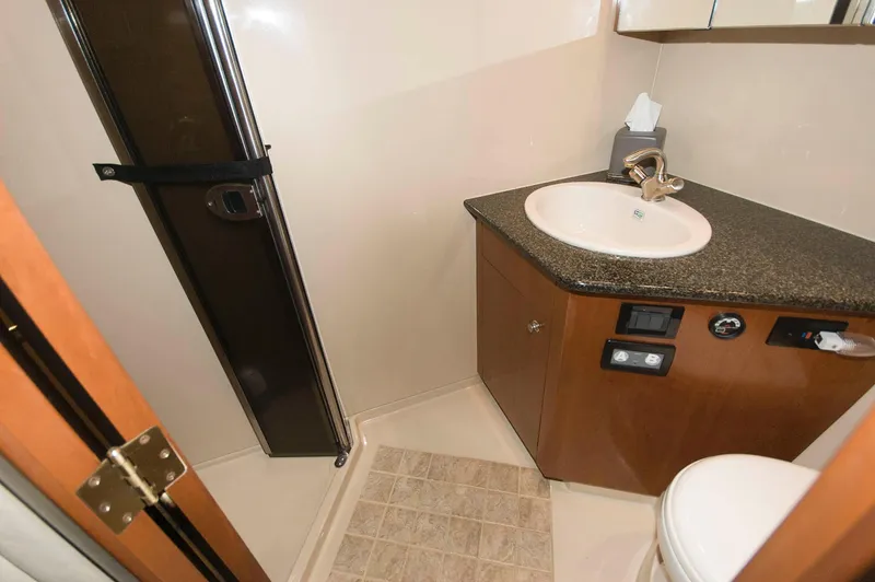 Slide: The Image of 2005 Cruisers Yachts 520 Express bathroom with sink and shower. - 30