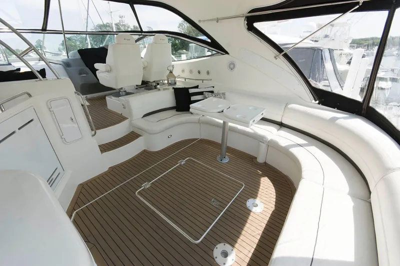 Slide: The Image of Interior of a 2005 Cruisers Yachts 520 Express with elegant seating arrangement. - 6