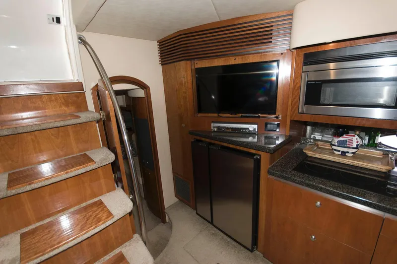 Slide: The Image of Interior of 2005 Cruisers Yachts 520 Express with kitchen and stairs. - 25
