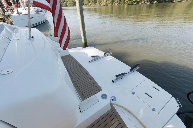Slide: The Image of Rear view of a 2005 Cruisers Yachts 520 Express by the water. - 5